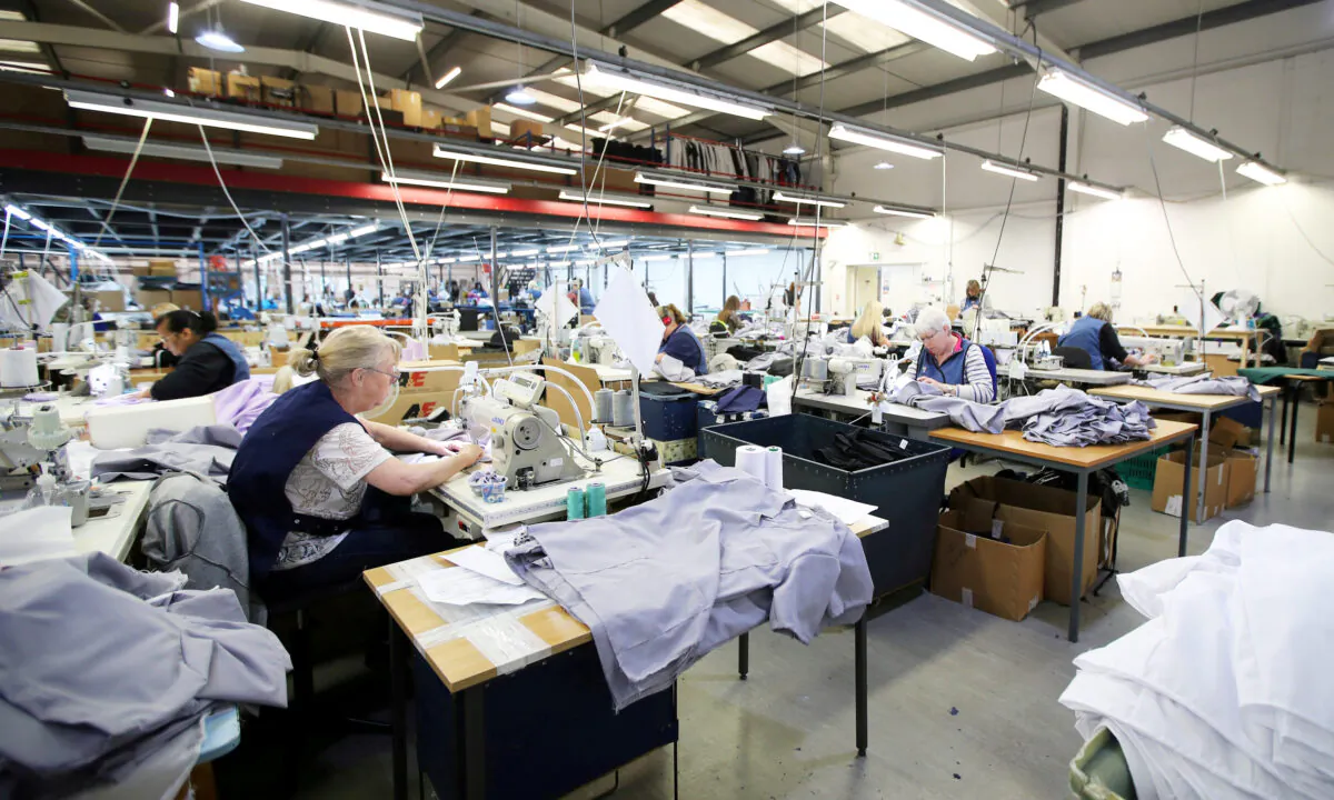 Tibard employees make uniforms for health workers at NHS at their factory in Dukinfield, Britain, on April 6, 2020. (Molly Darlington/Reuters)