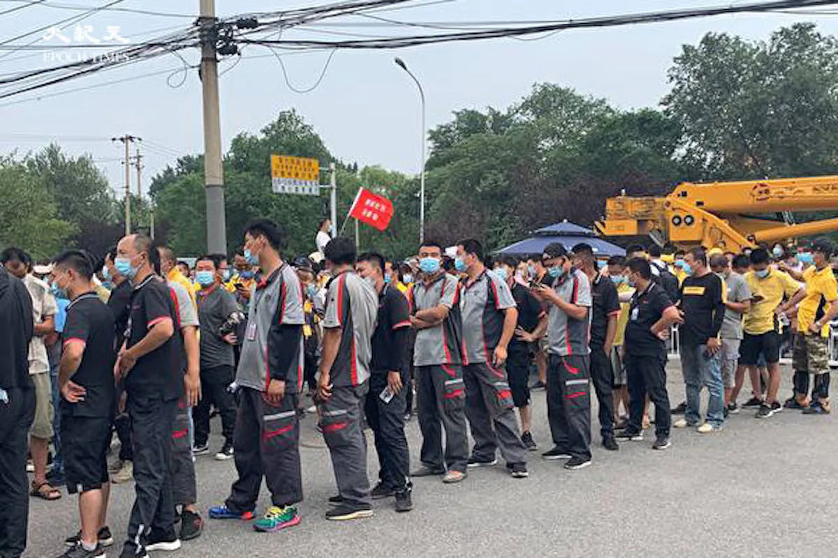 Couriers line up at a designated COVID-19 testing clinic in Sijiqing Town, Haidian, China on June 22, 2020. (The Epoch Times)