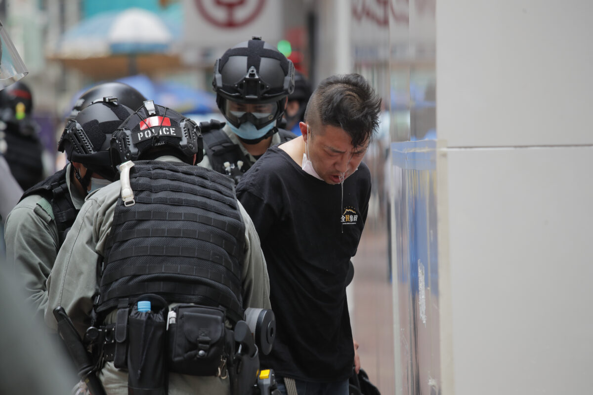 Police detain a protester