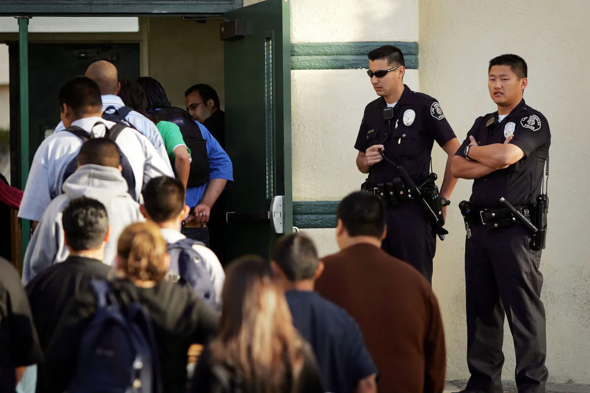 Los Angeles School Police officers watch high school students line up to pass through a security check point in a file photo. (David McNew/Getty Images)