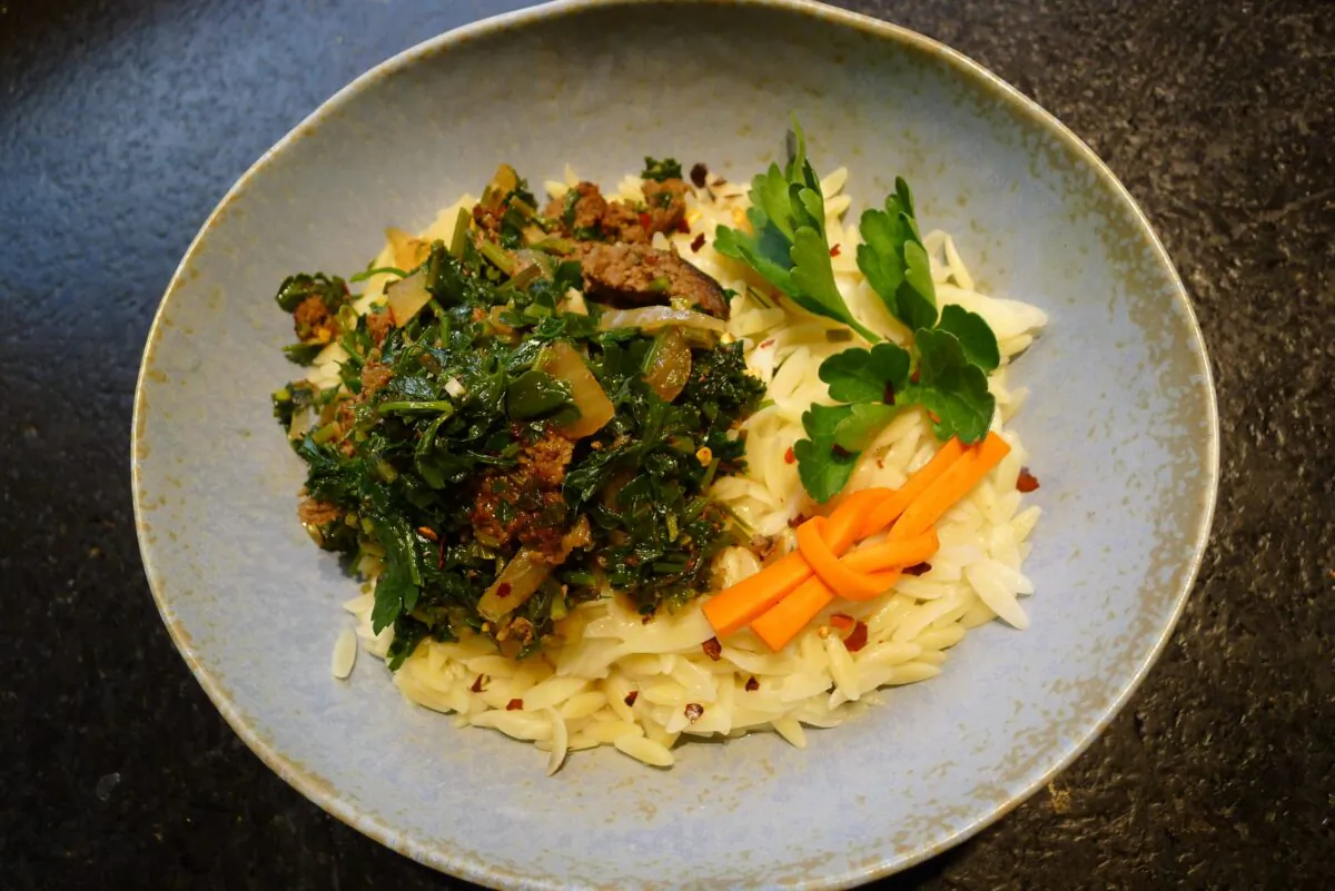 Parsley is cooked with ground beef, chicken stock, olive oil, and butter, then served over buttered orzo. (Ari LeVaux)