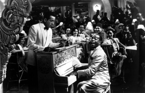 two men at piano in white jackets in "Casablanca"