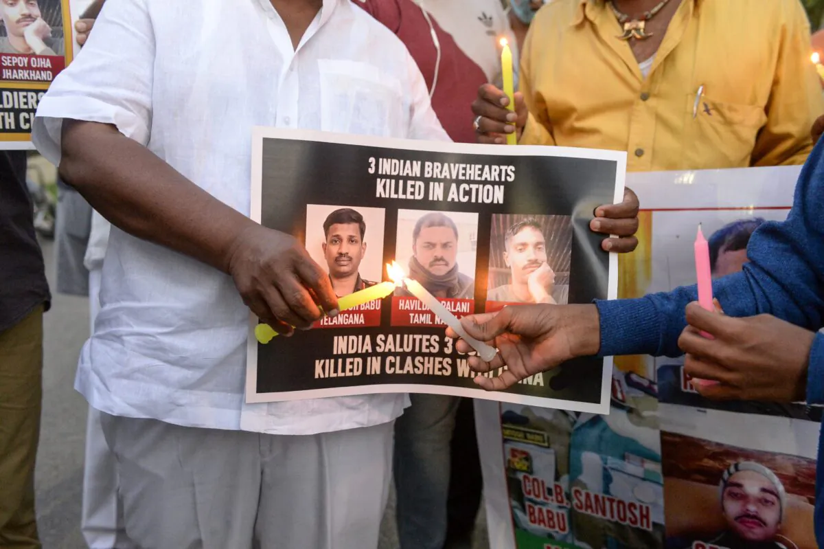 Members of City Youth organizations hold posters and light candles to pay tribute to the soldiers who lost their lives following a recent clash between India and China, in Hyderabad on June 17, 2020. (Noah Seelam/AFP via Getty Images)
