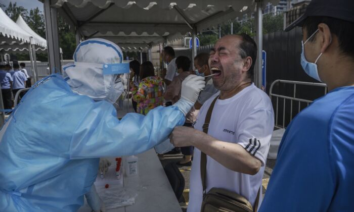 A Beijing resident receives the nucleic acid swab test for COVID-19 at a testing site in Beijing on July 1, 2020. (Kevin Frayer/Getty Images)