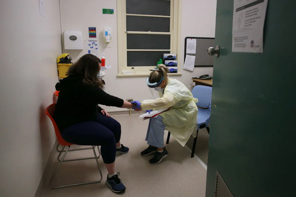 Nurse Catherine Askin performs a consultation with patient Rachel Roth at the COVID-19 and flu assessment clinic, Prince of Wales Hospital on May 12, 2020 in Sydney, Australia. (Lisa Maree Williams/Getty Images)