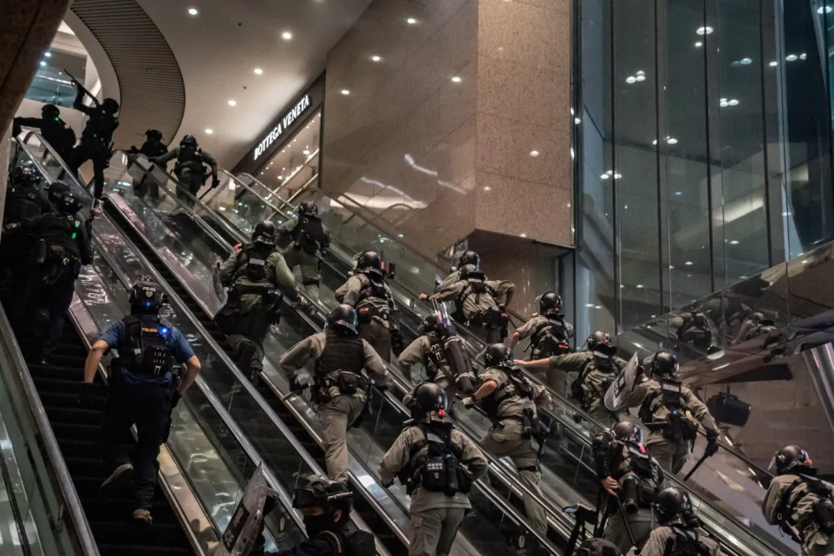 Riot police officers charge up escalators and shoot pepperball projectiles at a shopping mall during an anti-national security law demonstration  in Hong Kong, China, on July 1, 2020. (Anthony Kwan/Getty Images)