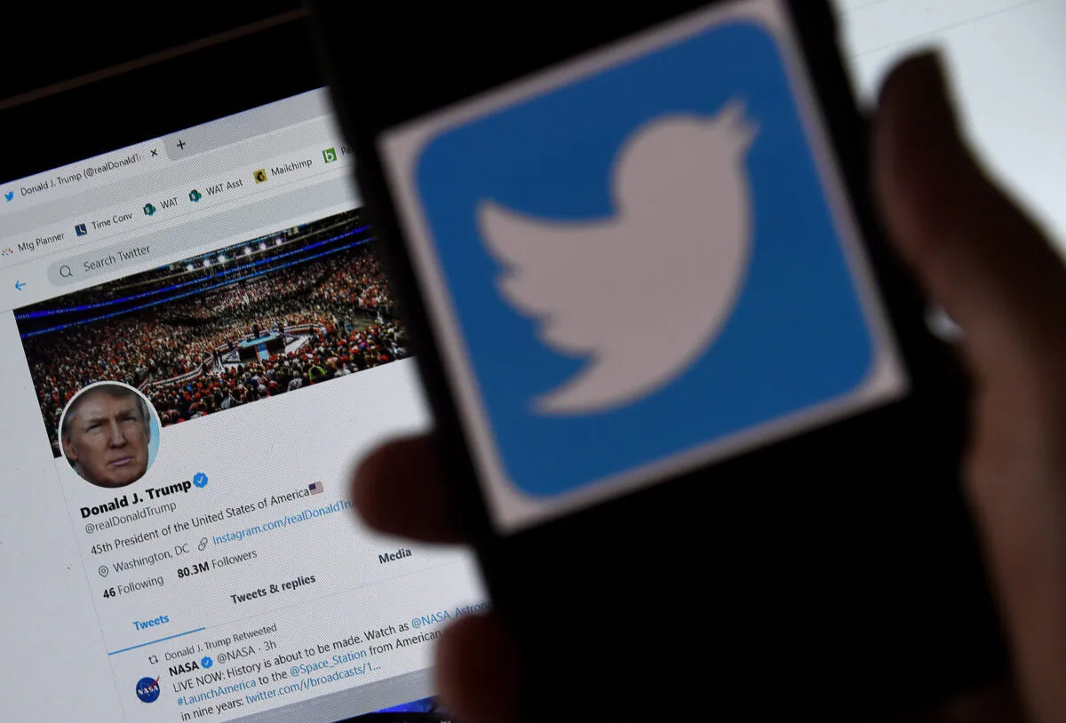In this photo illustration, a Twitter logo is displayed on a mobile phone with President Trump's Twitter page shown in the background  in Arlington, Va., on May 27, 2020. (Olivier Douliery/AFP/Getty Images)