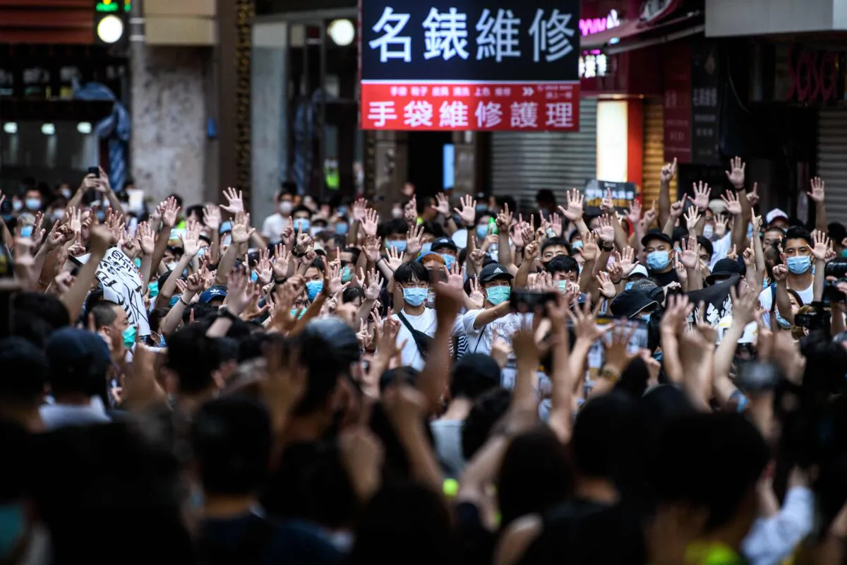Protesters chant slogans and gesture during a rally against the new national security law in Hong Kong on July 1, 2020, on the 23rd anniversary of the city's handover from Britain to China. (Anthony Wallace/AFP via Getty Images)