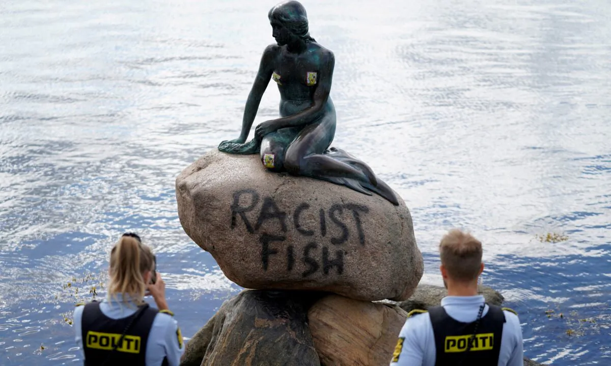 Graffiti reading "Racist Fish" is seen on a statue of the Little Mermaid in Copenhagen, Denmark, on July 3, 2020. (Ritzau Scanpix/Mads Claus Rasmussen via Reuters)