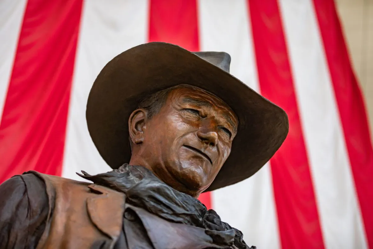 A statue of actor John Wayne is seen at John Wayne Airport, which serves Orange County, Calif., on June 26, 2020. The Democratic Party of Orange County has called for the statue to be removed and the airport renamed. (John Fredricks/The Epoch Times)