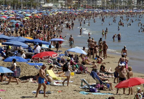 People visit the beach in the Spanish south-eastern town of Benidorm