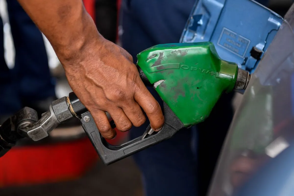 A person pumps petrol into a vehicle at a gas station in Caracas, Venezuela, on June 1, 2020. (Federico Parra/AFP via Getty Images)