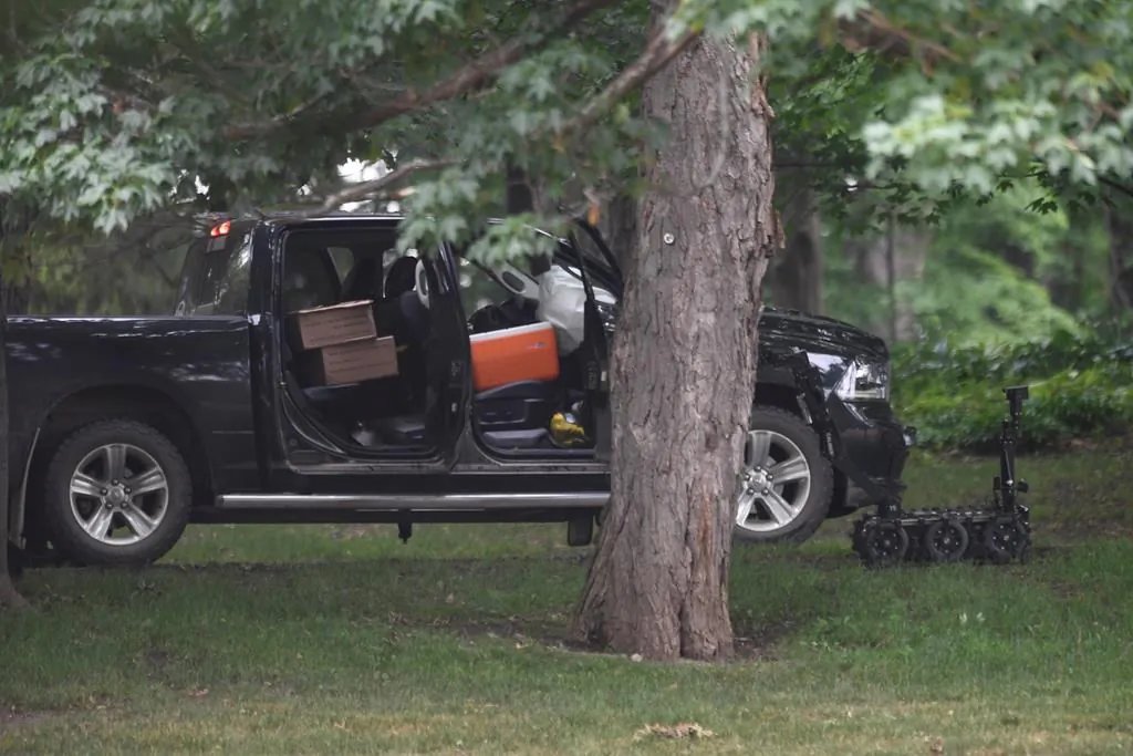 A police robot is shown near a pickup truck inside the grounds of Rideau Hall in Ottawa on July 2, 2020. (The Canadian Press/Adrian Wyld)