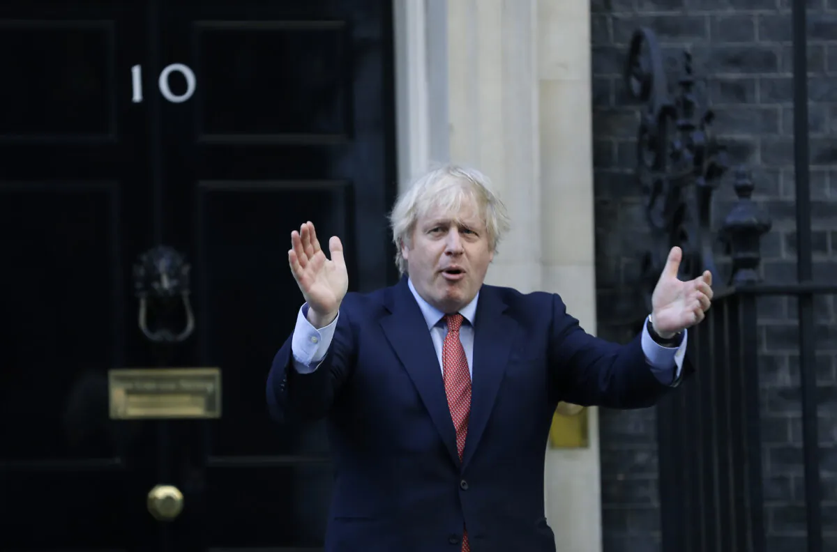 Britain's Prime Minister Boris Johnson applauds on the doorstep of 10 Downing Street in London on May 28, 2020. (Kirsty Wigglesworth/AP Photo)