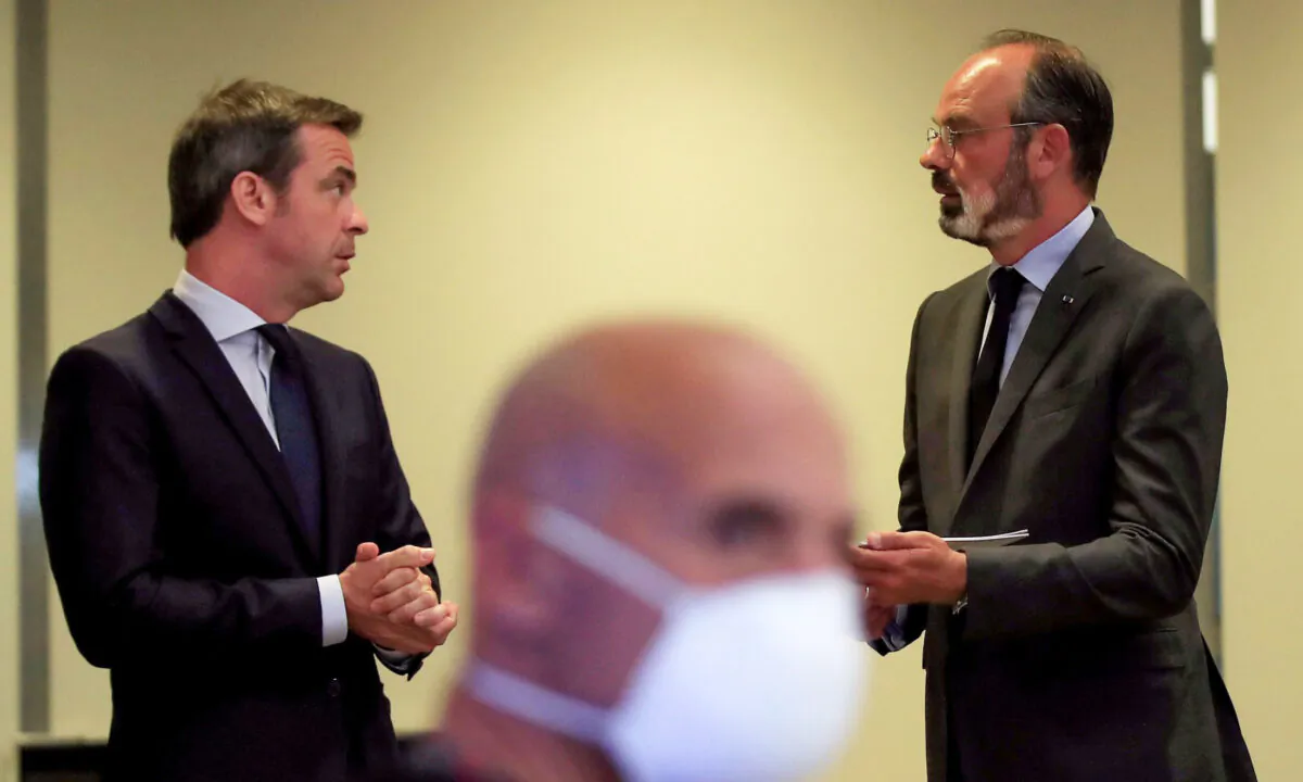 French Prime Minister Edouard Philippe (R) chats with French Minister for Solidarity and Health Olivier Veran at the Health Ministry in Paris, France, on May 25, 2020. (Michel Euler/POOL/AFP via Getty Images)