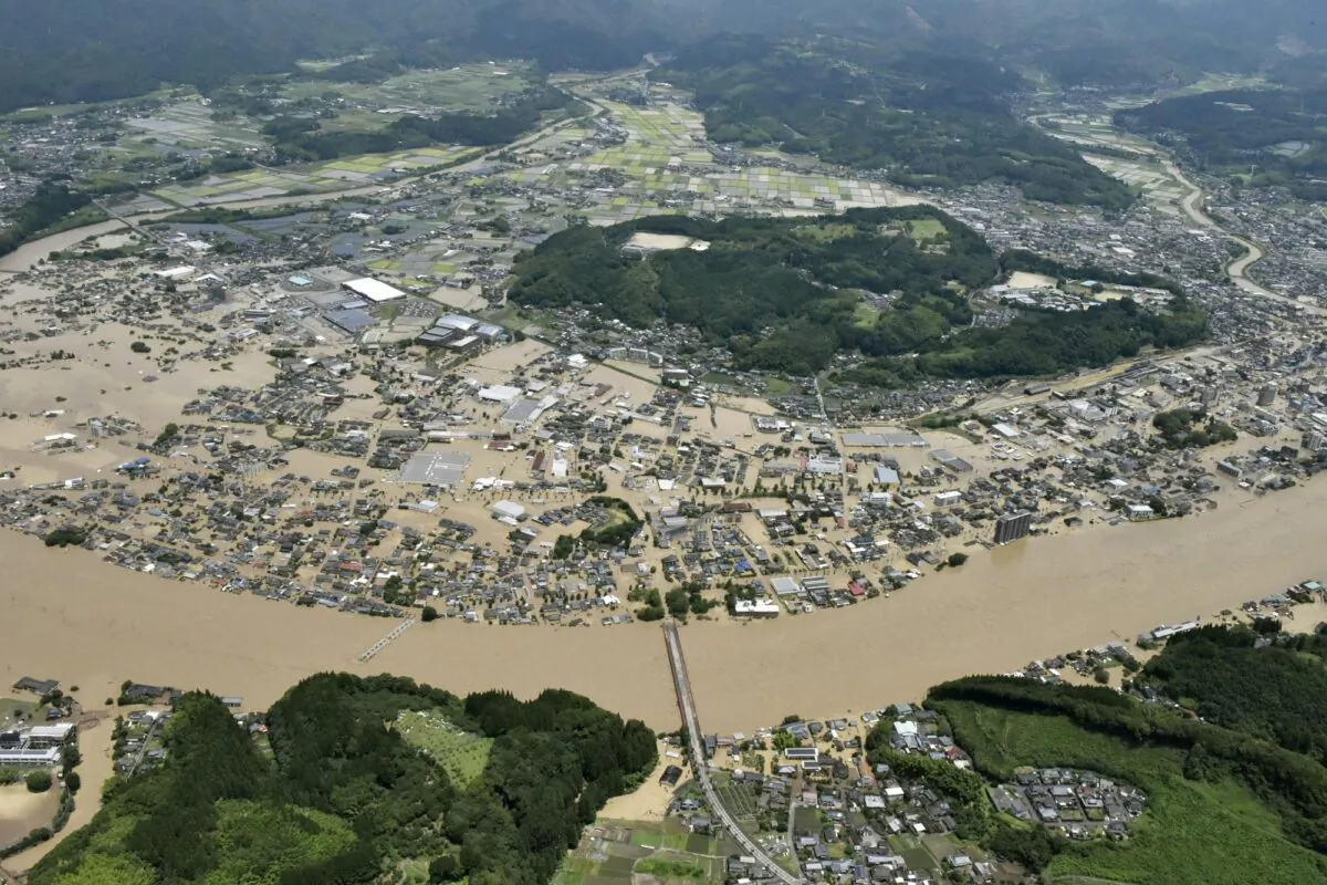 Areas are inundated in muddy waters that gushed out from the Kuma River in Hitoyoshi, Kumamoto prefecture, southwestern Japan on July 4, 2020. (Kyodo News via AP)