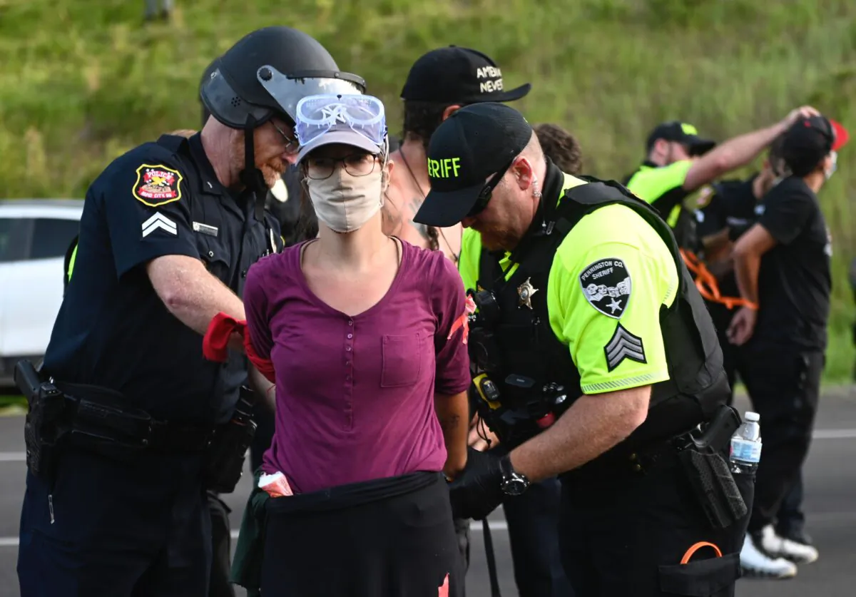 Police arrest a protester who helped block the road to Mount Rushmore National Monument in Keystone, S.D., on July 3, 2020. (Andrew Caballero-Reynolds/AFP via Getty Images)
