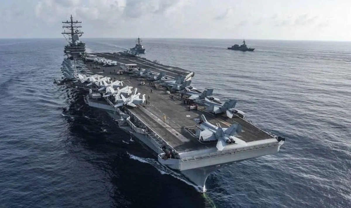 The aircraft carrier USS Ronald Reagan and the guided-missile destroyer USS Milius (C) conduct a photo exercise with Japan Maritime Self-Defense Force ships. (U.S. Navy photo by Mass Communication Specialist 2nd Class Kaila V. Peters/Released)