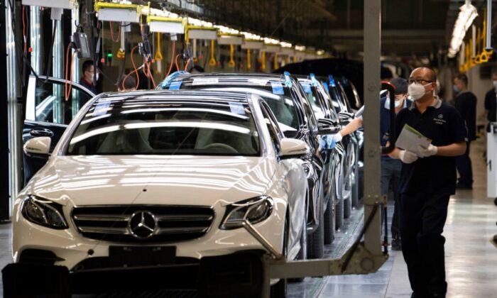 Workers inspect newly assembled cars at a Beijing Benz Automotive Co. Ltd factory, a German joint venture company for Mercedes-Benz, in Beijing, China, on May 13, 2020. (Ng Han Guan/AP Photo) 
