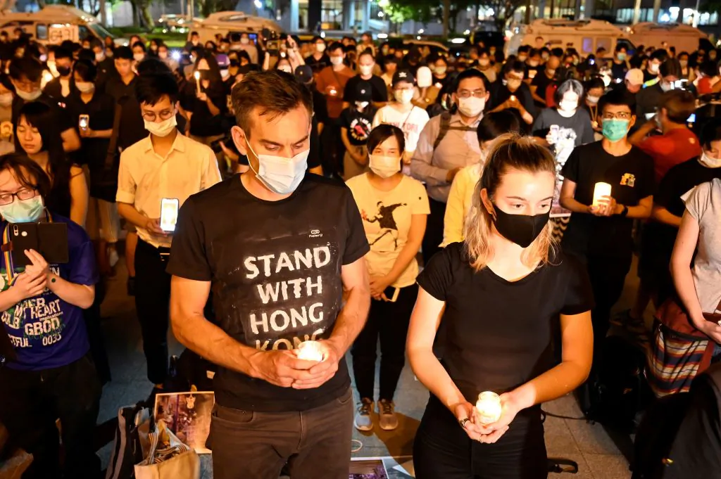 People hold candles in front of the Chiang Kai-shek Memorial Hall, also known as Free Square, to mark the 31st anniversary of the 1989 Tiananmen Square Massacre in Taipei, Taiwan, on June 4, 2020. (Sam Yeh/AFP via Getty Images)