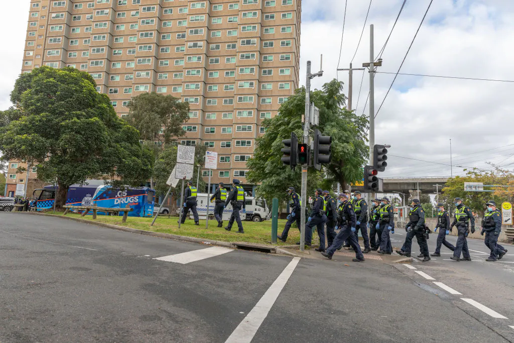 Protective service police officers walk towards the Flemington Public housing flats on patrol in Melbourne, Australia on July 05, 2020. (Asanka Ratnayake/Getty Images)