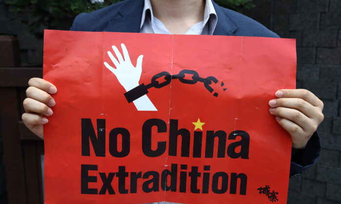 A South Korean man holds a placard during a rally to support Hong Kong's protest over extradition law in front of Chinese embassy in Seoul, South Korea, on June 17, 2019. (Chung Sung-jun/Getty Images)