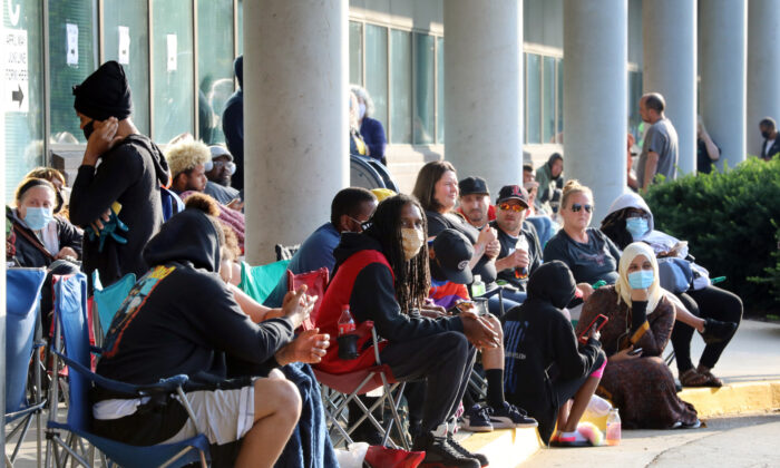 Hundreds of unemployed Kentucky residents wait in long lines outside the Kentucky Career Center on June 19, 2020 in Frankfort, Kentucky. (John Sommers II/Getty Images)