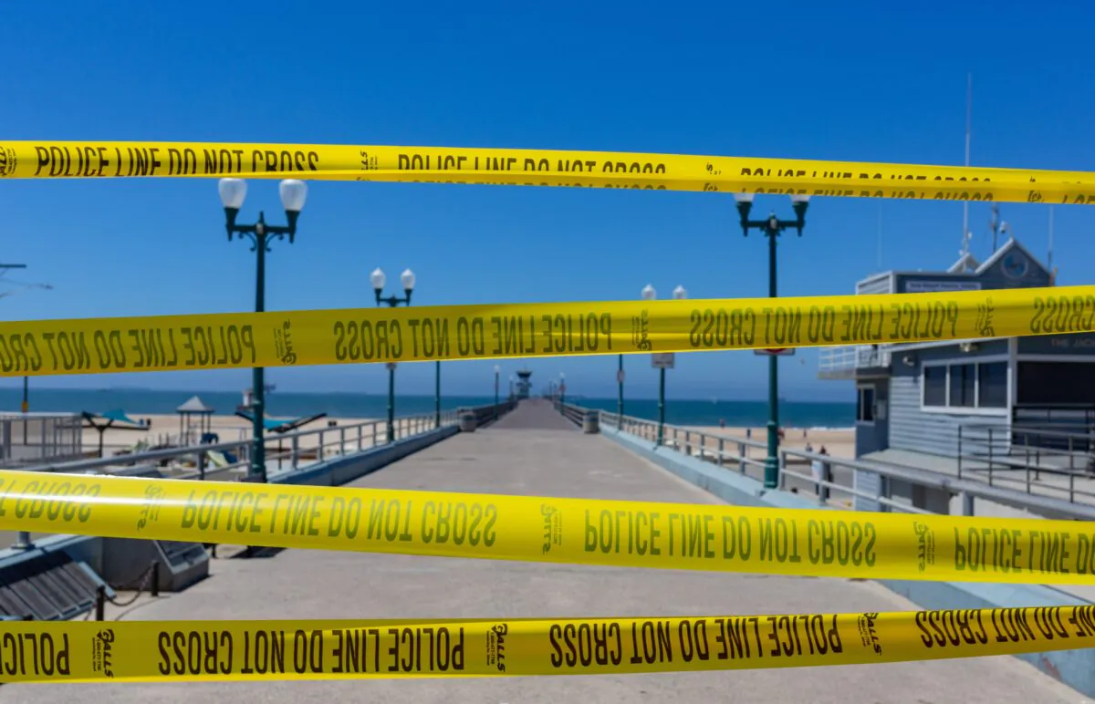 Police tape blocks the entry to the Seal Beach Pier in Seal Beach, Calif., on July 4, 2020. (John Fredricks/The Epoch Times)