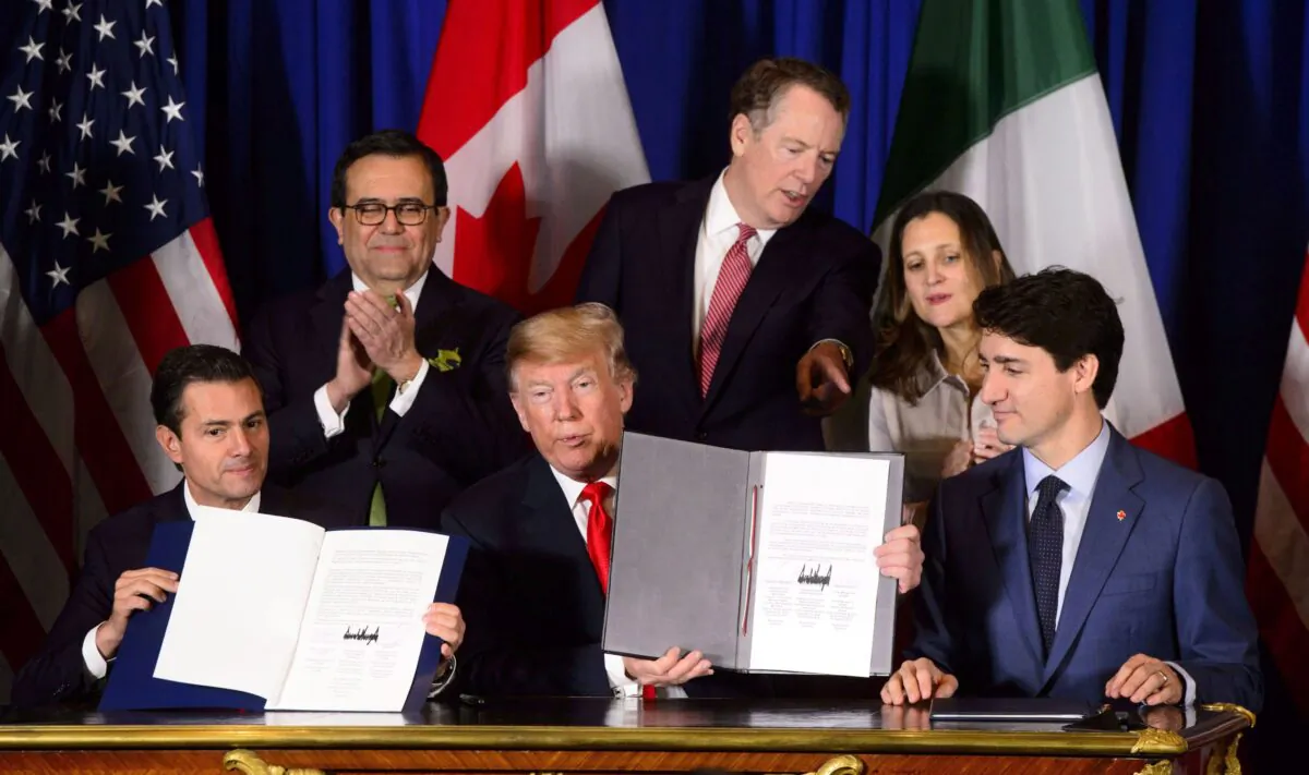 (Clockwise from top L) Mexican Secretary of Economy Ildefonso Guajardo Villarreal, U.S. Trade Representative Robert Lighthizer, Foreign Affairs Minister Chrystia Freeland, Prime Minister Justin Trudeau, U.S. President Donald Trump, and Mexican President Pena Nieto participate in a signing ceremony for the United States-Mexico-Canada Agreement in Buenos Aires, Argentina, on Nov. 30, 2018. The new trade pact came into effect on July 1, 2020. (The Canadian Press/Sean Kilpatrick)