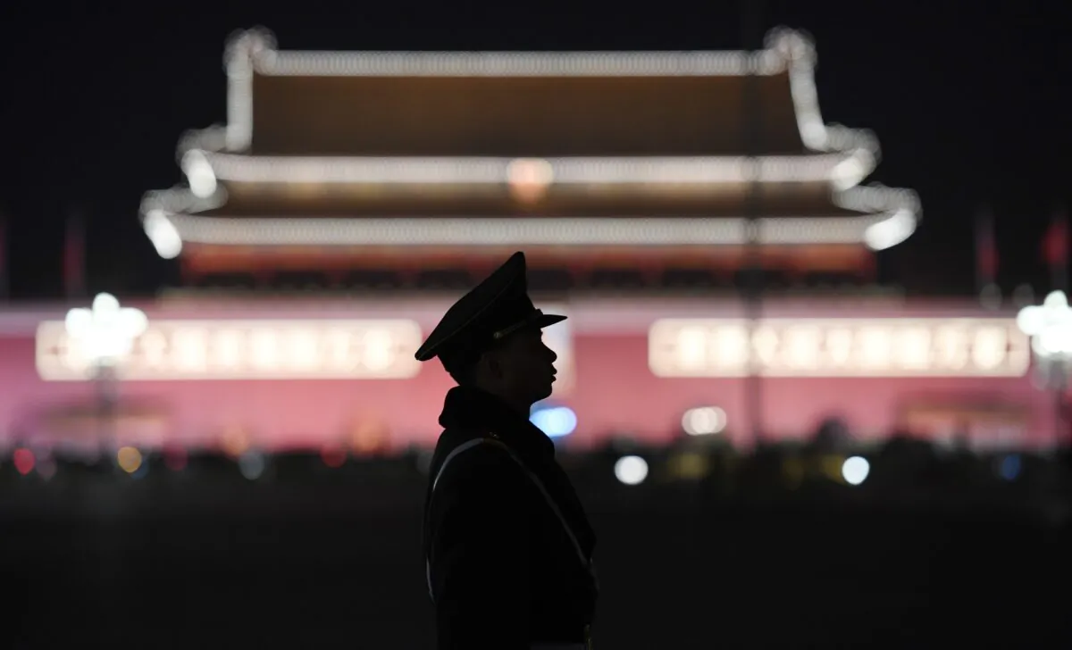 A paramilitary police officer stands guard in Tiananmen Square after a plenary session of the National People's Congress in the adjacent Great Hall of the People in Beijing on March 11, 2018. (Greg Baker/AFP via Getty Images)