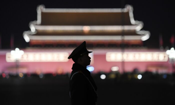 A paramilitary police officer stands guard in Tiananmen Square after a plenary session of the National People's Congress in the adjacent Great Hall of the People in Beijing on March 11, 2018. (Greg Baker/AFP via Getty Images)