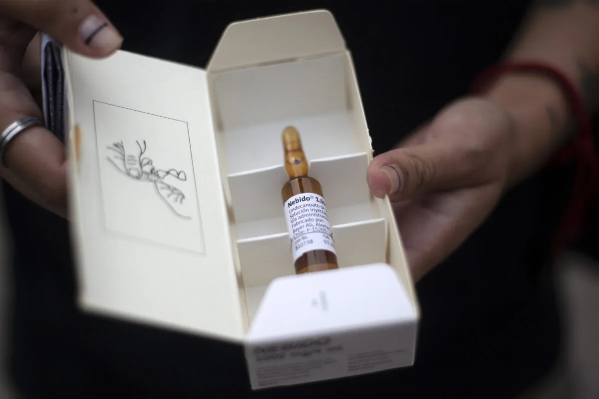 A transgender individual shows a testosterone ampoule at a hospital in Santiago, Chile, on Jan. 8, 2020. (Claudio Reyes/AFP via Getty Images)