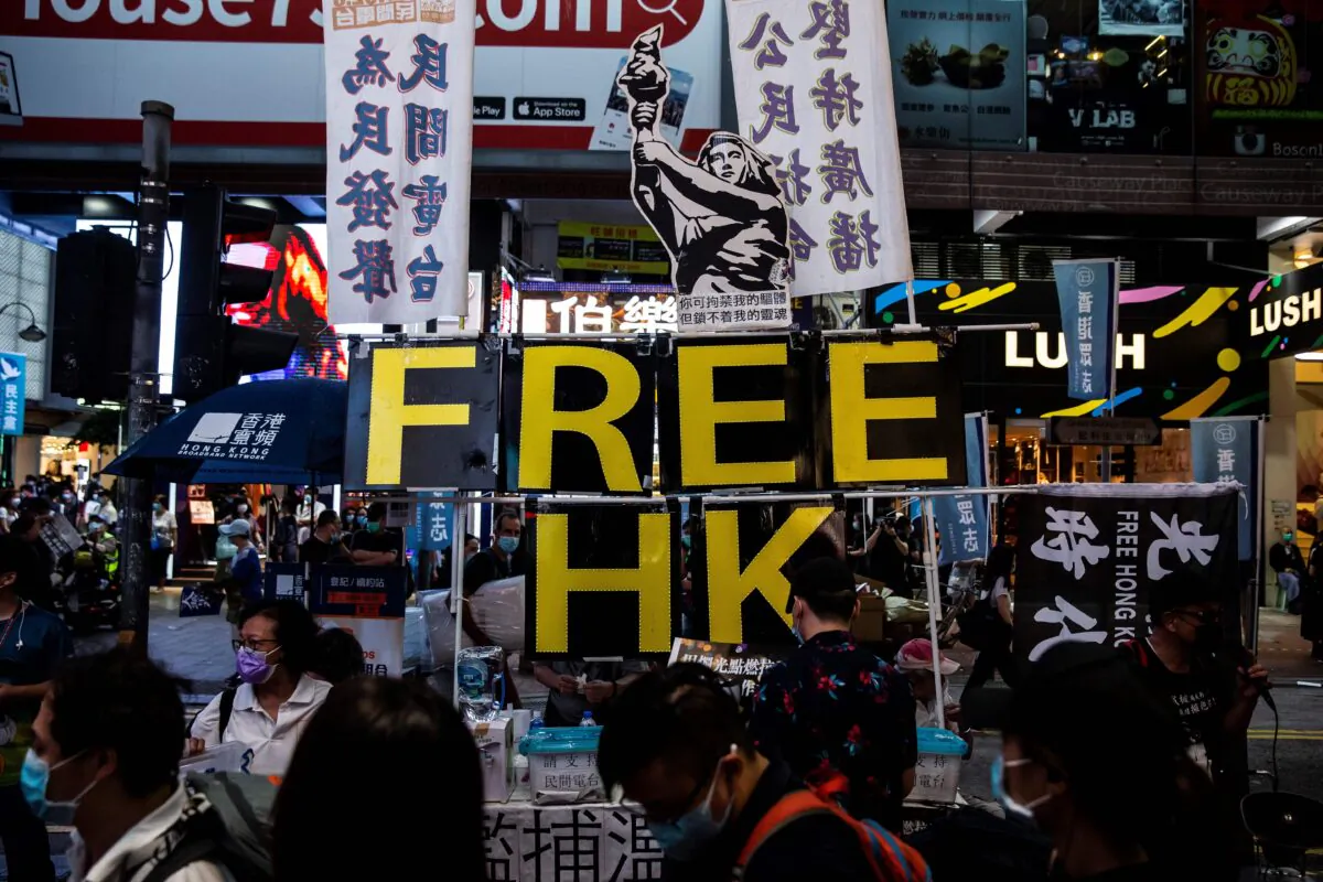 A large display showing the Goddess of Democracy (top C) and lettering that reads 'Free HK' is seen a stall on a pavement near Victoria Park in Hong Kong on June 4, 2020, after an annual vigil that traditionally takes place in the park to mark the 1989 Tiananmen Square crackdown was banned on public health grounds because of the coronavirus pandemic. (Isaac Lawrence/AFP via Getty Images)