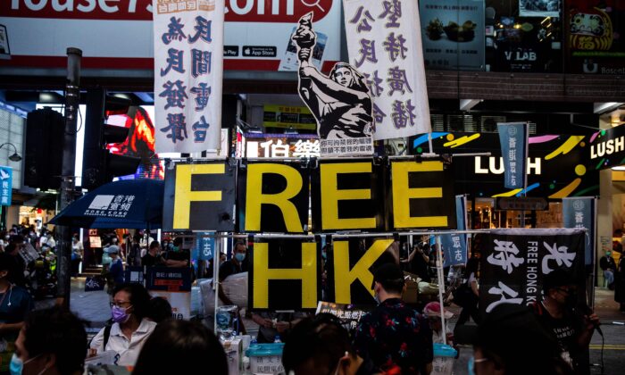 A large display showing the Goddess of Democracy (top C) and lettering that reads 'Free HK' is seen a stall on a pavement near Victoria Park in Hong Kong on June 4, 2020, after an annual vigil that traditionally takes place in the park to mark the 1989 Tiananmen Square crackdown was banned on public health grounds because of the coronavirus pandemic. (Isaac Lawrence/AFP via Getty Images)