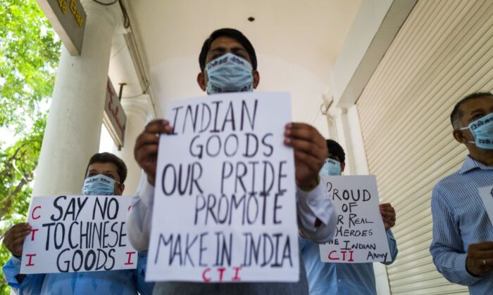 Anti-China protesters display placards urging citizens to boycott Chinese goods at a market in New Delhi on June 17, 2020. (Jewel Samad/AFP via Getty Images)
