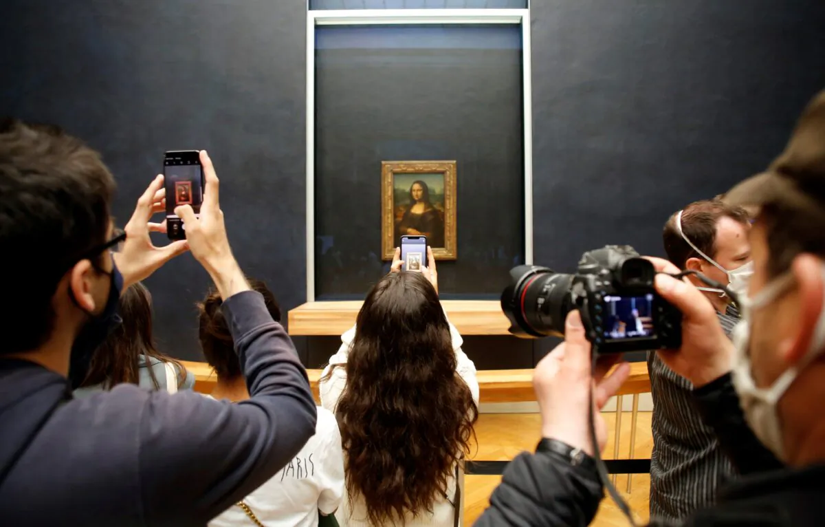 Visitors take photos of the Leonardo da Vinci's painting Mona Lisa, in Paris, France, on July 6, 2020. (Thibault Camus/AP Photo)