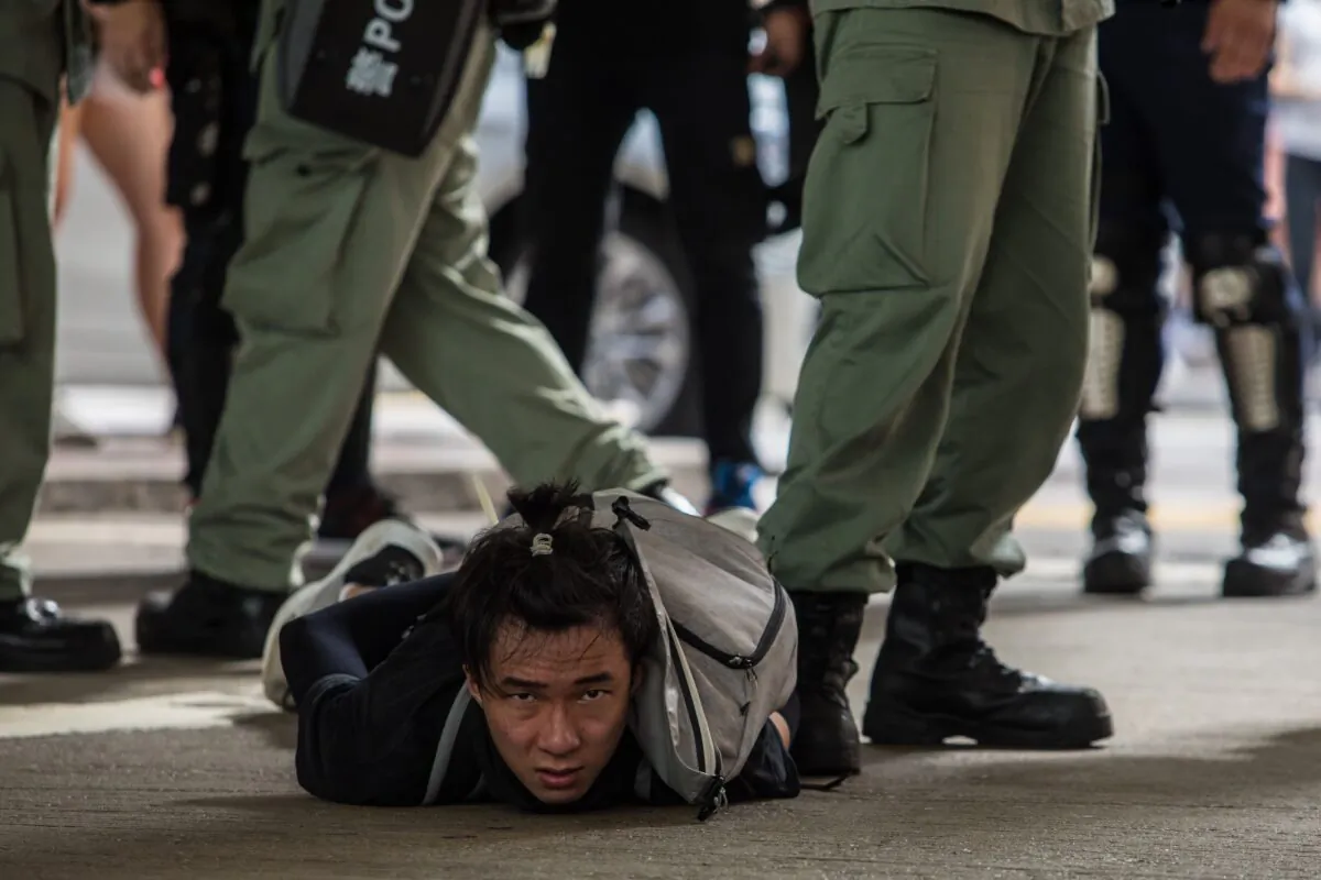 Riot police detain a man as they clear protesters taking part in a rally against a new national security law in Hong Kong on July 1, 2020, on the 23rd anniversary of the city's handover from Britain to China. (Dale de la Rey/AFP via Getty Images)