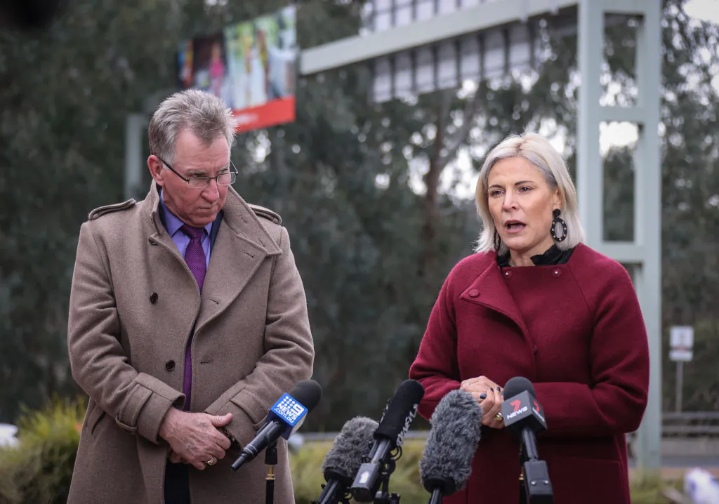Mayor of Albury, Kevin Mack (L) reacts as he listens to the Mayor of Wodonga, Anna Speedie (R) during a media conference on July 7, 2020 in Albury, Australia. The NSW-Victoria border will close at 11:59 p.m. on Tuesday evening due to a large spike in COVID-19 cases in Victoria. (David Gray/Getty Images)