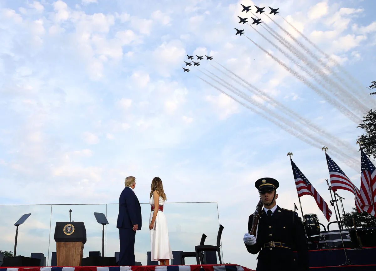 President Donald Trump and first lady Melania Trump watch the U.S. Navy Blue Angels and U.S. Air Force Thunderbirds perform a flyover near the White House in Washington on July 4, 2020. (Tasos Katopodis/Getty Images)