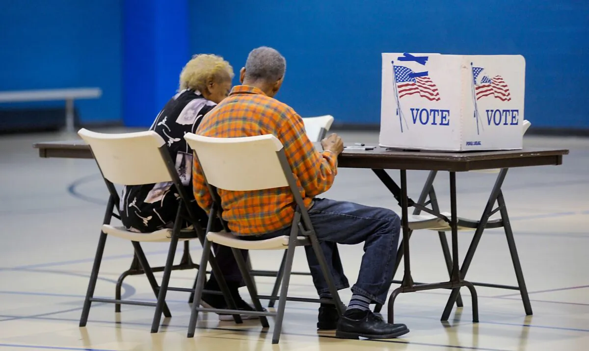 An elderly couple reads a ballot prior to voting in Durham, N.C., on Nov. 8, 2016. (Sara D. Davis/Getty Images)