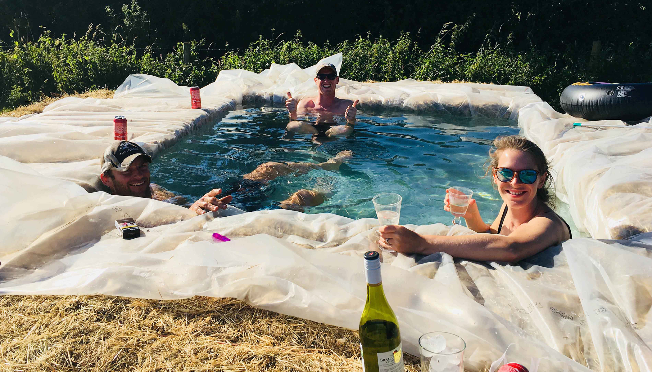 Family Build Makeshift Swimming Pool Out Of Hay Bales In Backyard During Heatwave