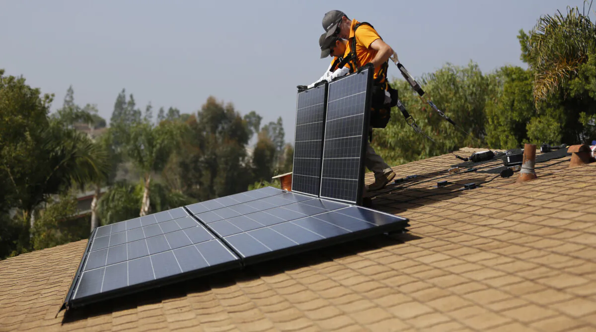 Vivint Solar technicians install solar panels on the roof of a house in Mission Viejo, Calif., on Oct. 25, 2013. (Mario Anzuoni/Reuters)
