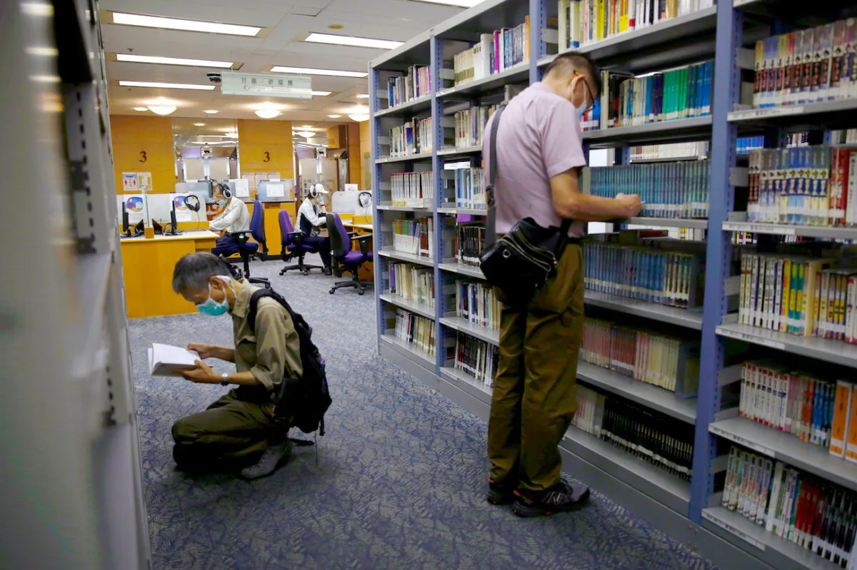 People read books at Hong Kong Central Library after democracy activists' books were taken down due to the national security law in Hong Kong, on July 6, 2020. (Tyrone Siu/Reuters)