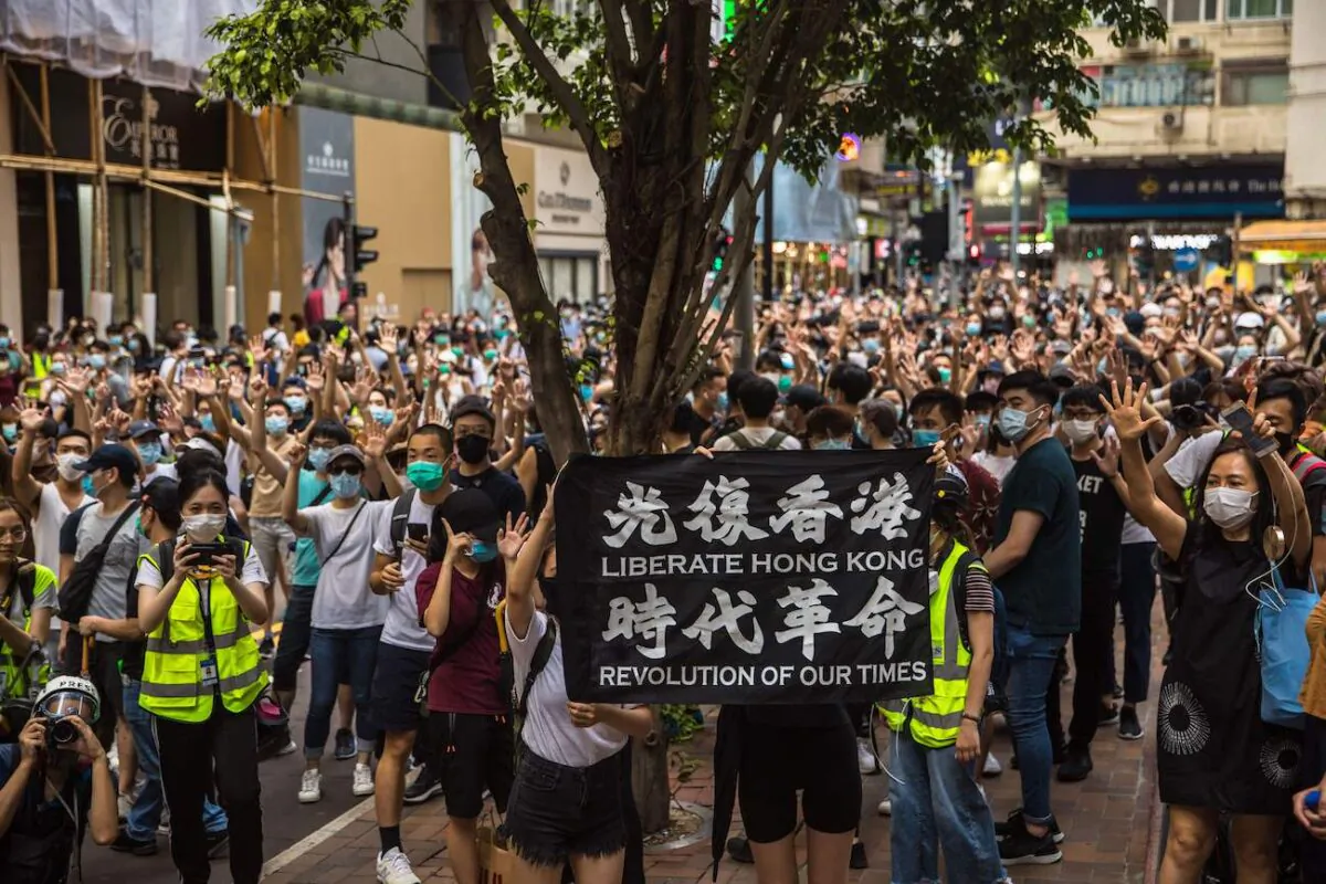 Protesters chant slogans during a rally against the new National Security Law in Hong Kong on July 1, 2020, on the 23rd anniversary of the city's handover from Britain to China. Hong Kong police made the first arrests under Beijing's new law on July 1. (Dale de la Rey/AFP via Getty Images)