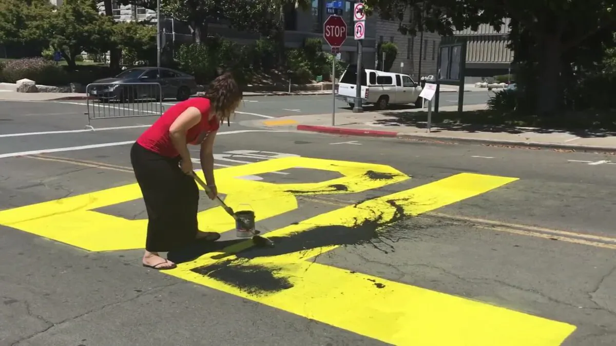 Nichole Anderson, 42, from California painting over a community's Black Lives Matter mural. (From Youtube/Kerry Leidich)