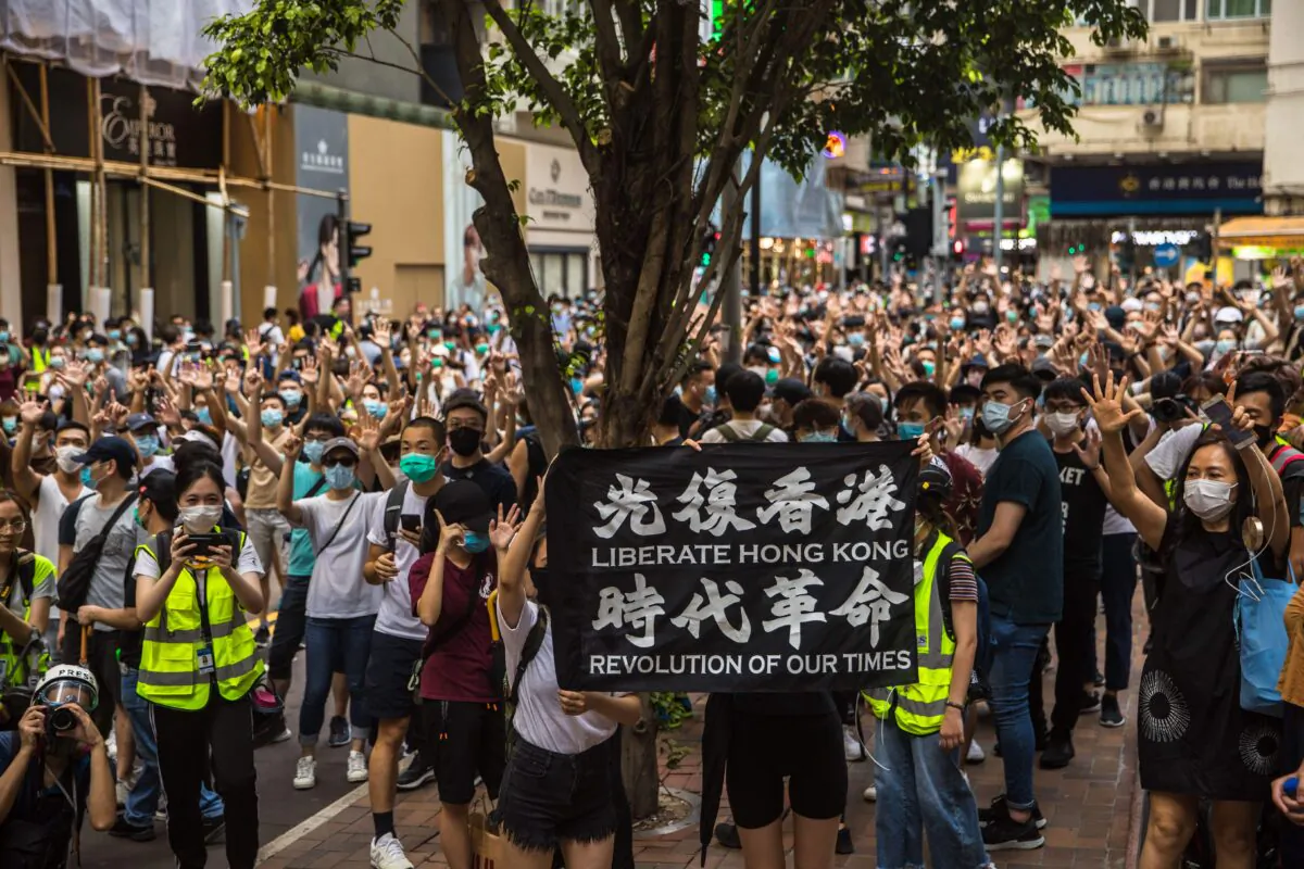 Protesters chant slogans during a rally against Beijing's new national security law in Hong Kong on July 1, 2020. (DALE DE LA REY/AFP via Getty Images)