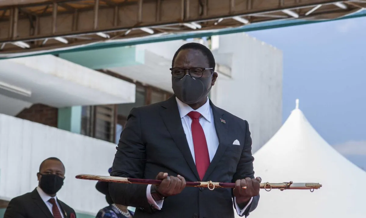 Malawi President elect Lazarus Chakwera shows the sword of office to the people after he received it from the Commander of the Malawi Defence Force, Gen. Peter Namathanga, during his inauguration at the Kamuzu Baracks, the Malawi Defence Fore Headquarters, in Lilongwe, on July 6, 2020. (Amos Gumulira/AFP via Getty Images)