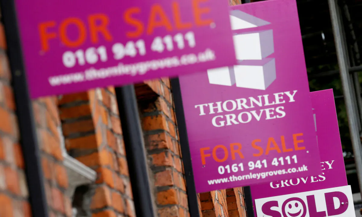 Estate agents boards are seen outside a row of terraced houses in Manchester, Britain, on July 8, 2020. (Phil Noble/Reuters)