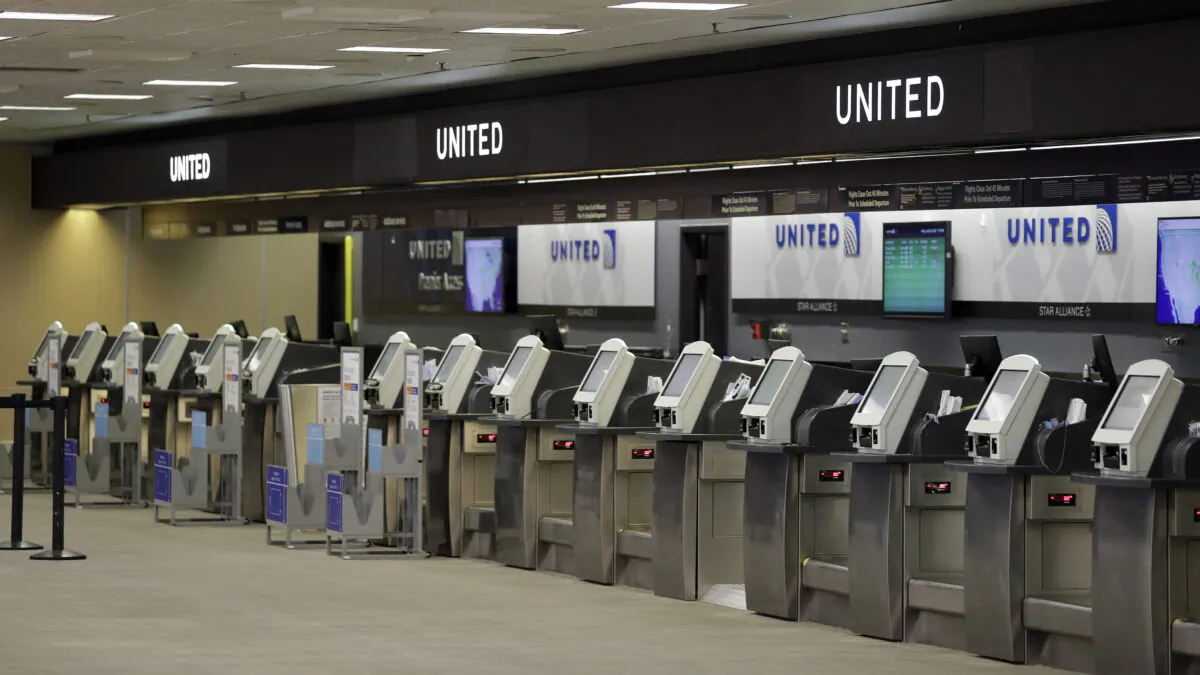 Empty United Airlines ticket machines are shown at the Tampa International Airport in Tampa, Fla., on April 24, 2020 (Chris O'Meara/AP Photo)