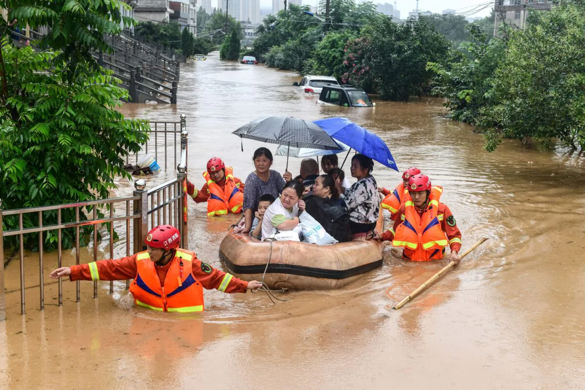 Rescuers evacuate flood-affected residents following heavy rain in Jiujiang in China's central Jiangxi province on July 8, 2020. (STR/AFP via Getty Images)